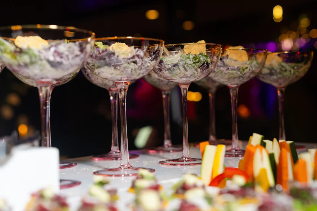 Champagne coupes and catered appetizers at an event reception